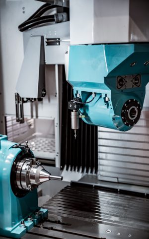 Metalworking CNC milling machine. Cutting metal modern processing technology. Small depth of field. Warning - authentic shooting in challenging conditions. A little bit grain and maybe blurred.